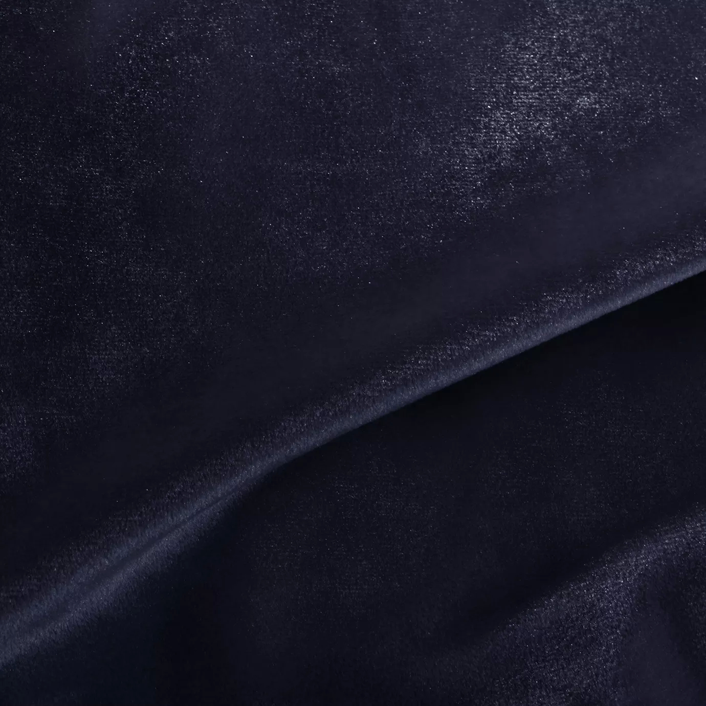 Elegant close-up of a Silky Velvet 411 fabric swatch in a deep and luminous dark blue tone, showcasing its smooth texture and the delicate folds that highlight its intense and silky sheen.