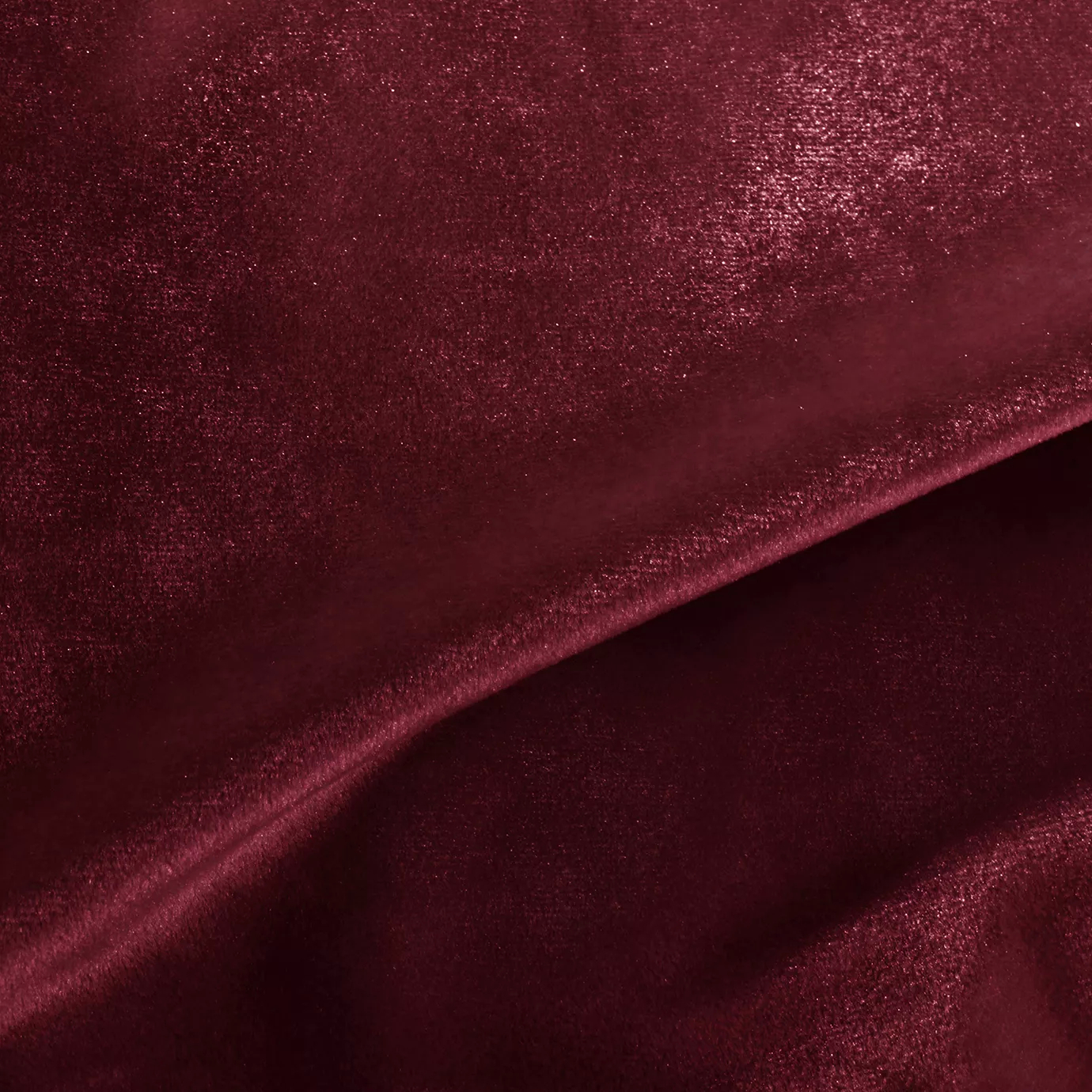 Elegant close-up of a Silky Velvet 422 fabric swatch in a luminous and rich burgundy red tone, showcasing its smooth texture and the delicate folds that highlight its deep and silky sheen.