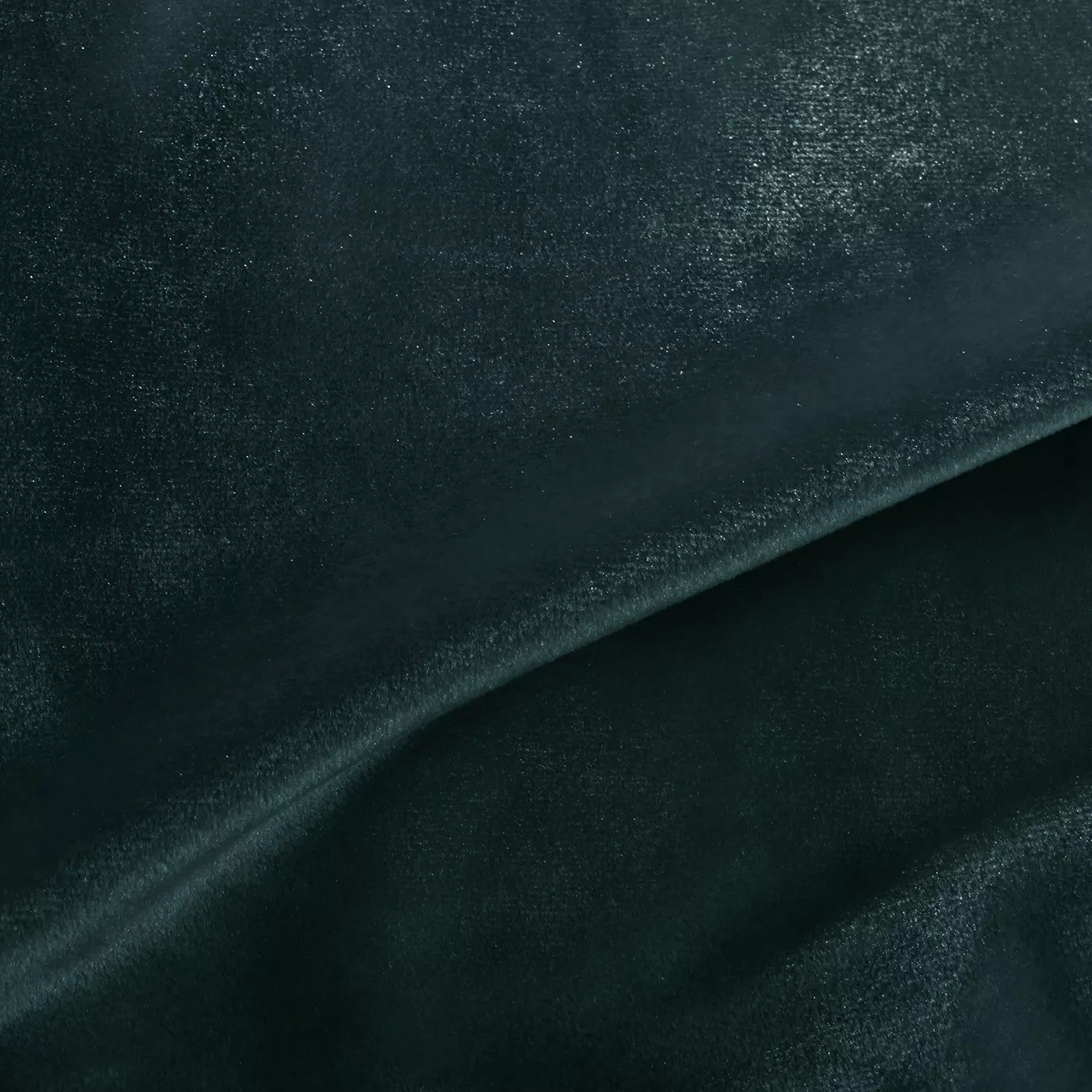 Elegant close-up of a Silky Velvet 429 fabric swatch in a deep and luminous emerald green tone, showcasing its smooth texture and the delicate folds that highlight its intense and silky sheen.