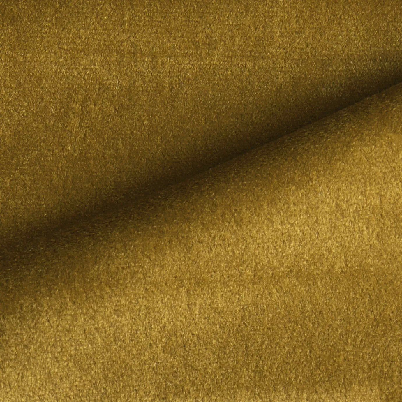 Elegant close-up of a Radiance Velvet Honey fabric swatch in a luminous and golden honey tone, showcasing its velvety texture and the gentle folds that highlight its warm and welcoming elegance.