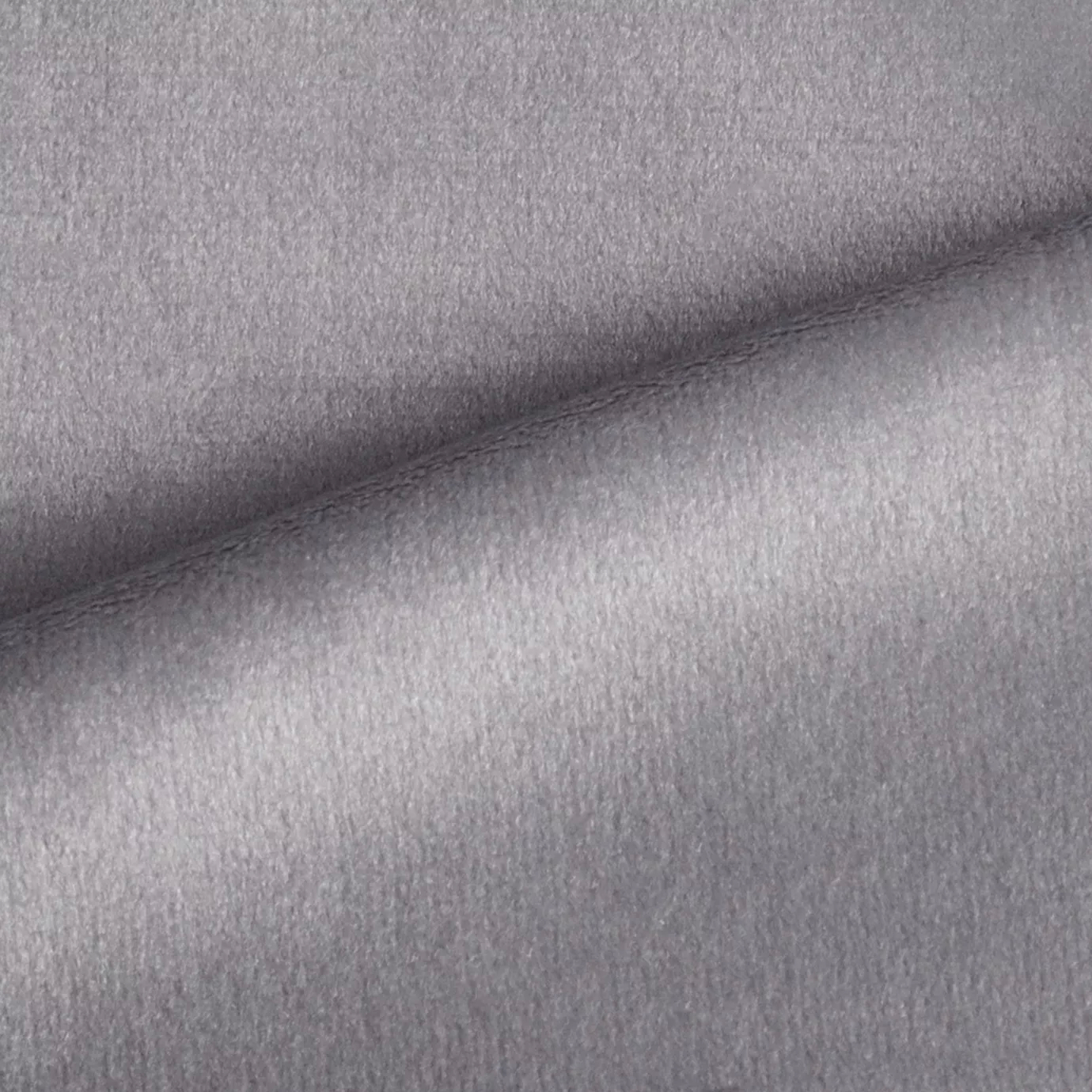 Elegant close-up of a Radiance Velvet Light Gray fabric swatch in a light and luminous gray tone, showcasing its velvety texture and a subtle sheen that gives it a feeling of lightness and sophistication.