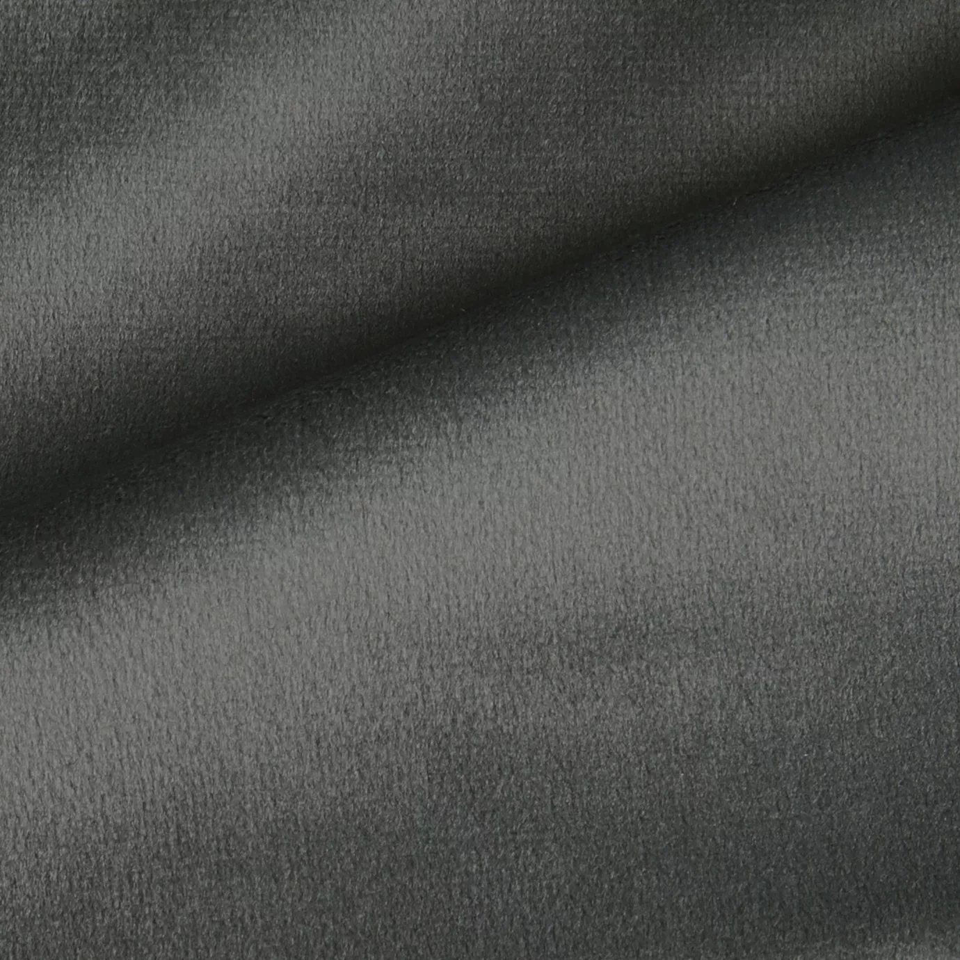 Elegant close-up of a Radiance Velvet Stone fabric swatch in a light and soft gray tone, showcasing its velvety texture and a subtle sheen that gives it a feeling of natural and timeless elegance.