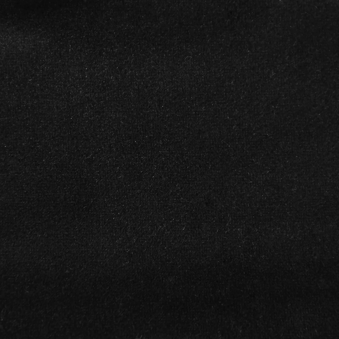 Soft and elegant close-up of a Lux Velvet Deep Black 0968 fabric swatch in a deep and intense black tone, showcasing its velvety texture and a delicate sheen that gives it a feeling of comfort and sophisticated elegance.