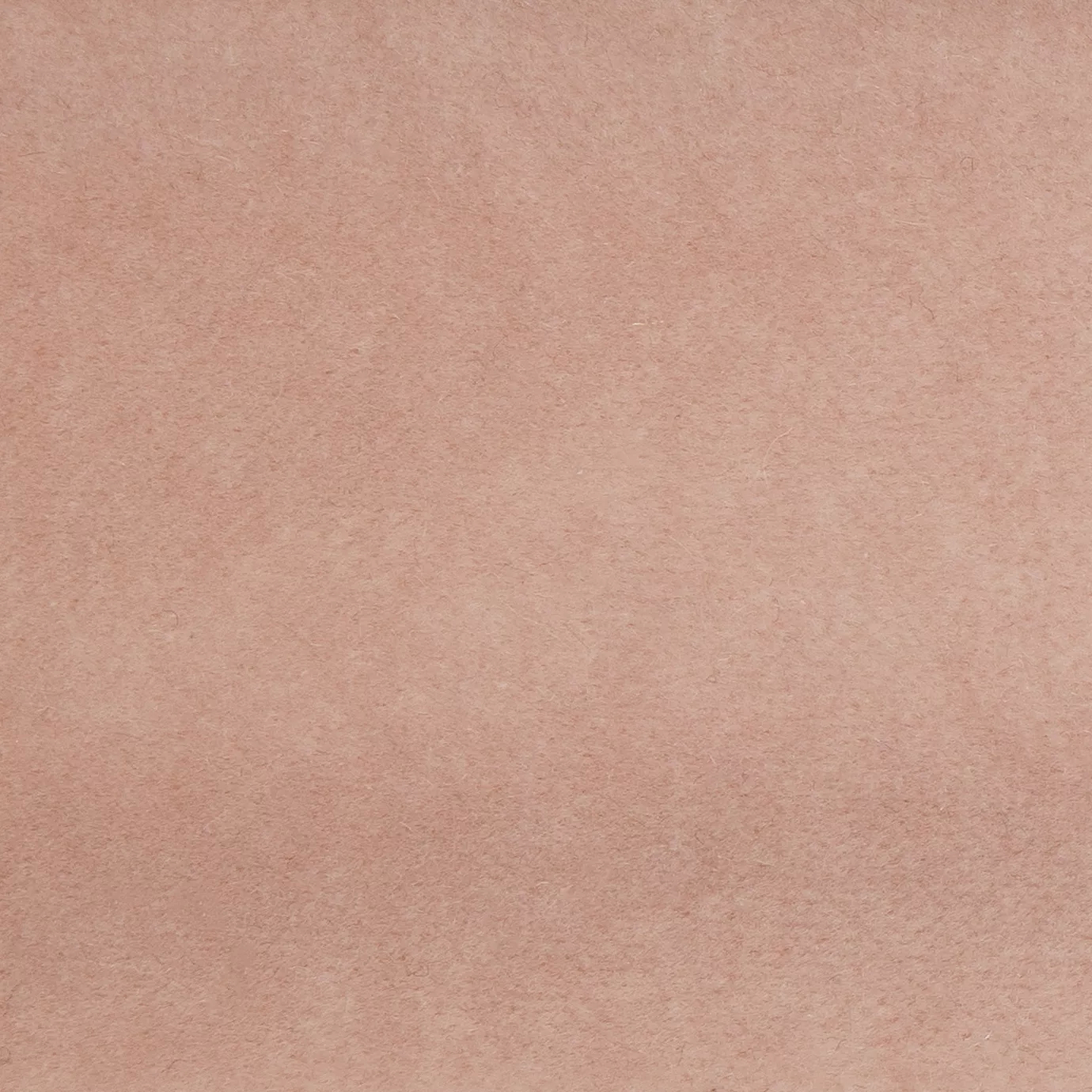 Soft and elegant close-up of a Lux Velvet Natural Nude 1601 fabric swatch in a natural and soft nude tone, showcasing its velvety texture and a delicate sheen that gives it a feeling of comfort and understated elegance.