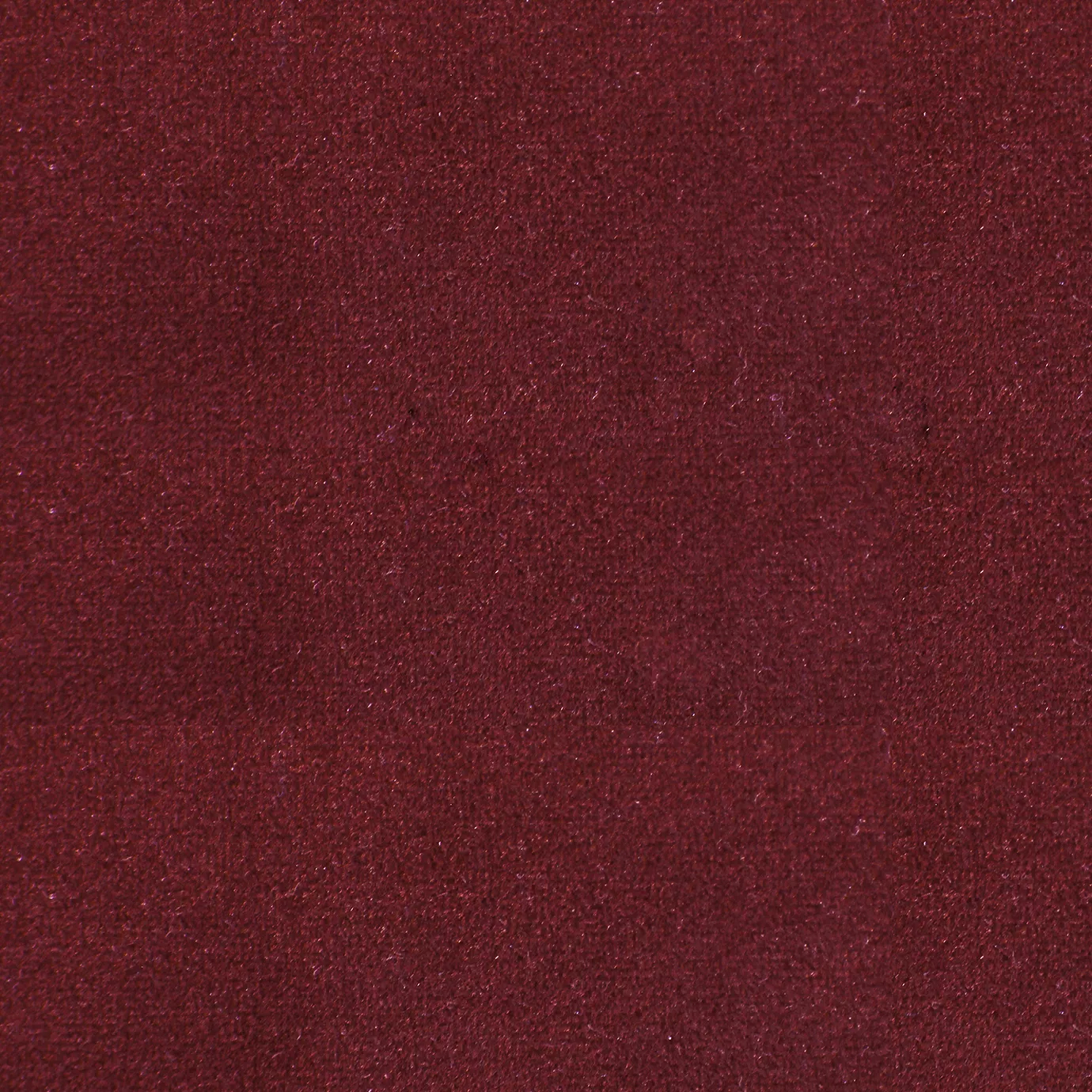 Soft and elegant close-up of a Lux Velvet Ruby Wine 0339 fabric swatch in a rich and sophisticated ruby wine tone, showcasing its velvety texture and a delicate sheen that gives it a feeling of comfort and rich elegance.