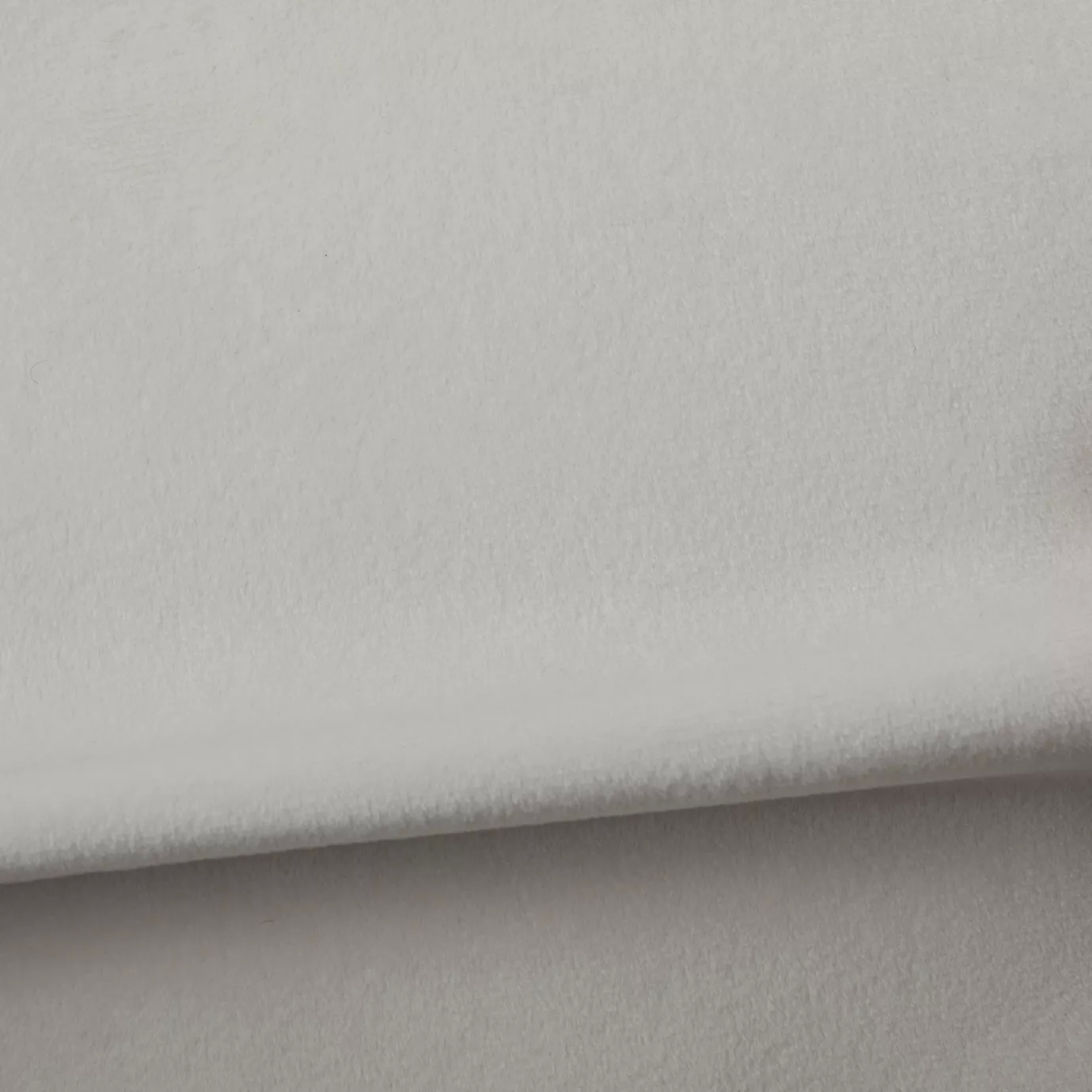 Soft and elegant close-up of a Venice Velvet 01 fabric swatch in a soft and luminous white tone, showcasing its velvety texture and a delicate sheen that gives it a feeling of comfort and timeless elegance.