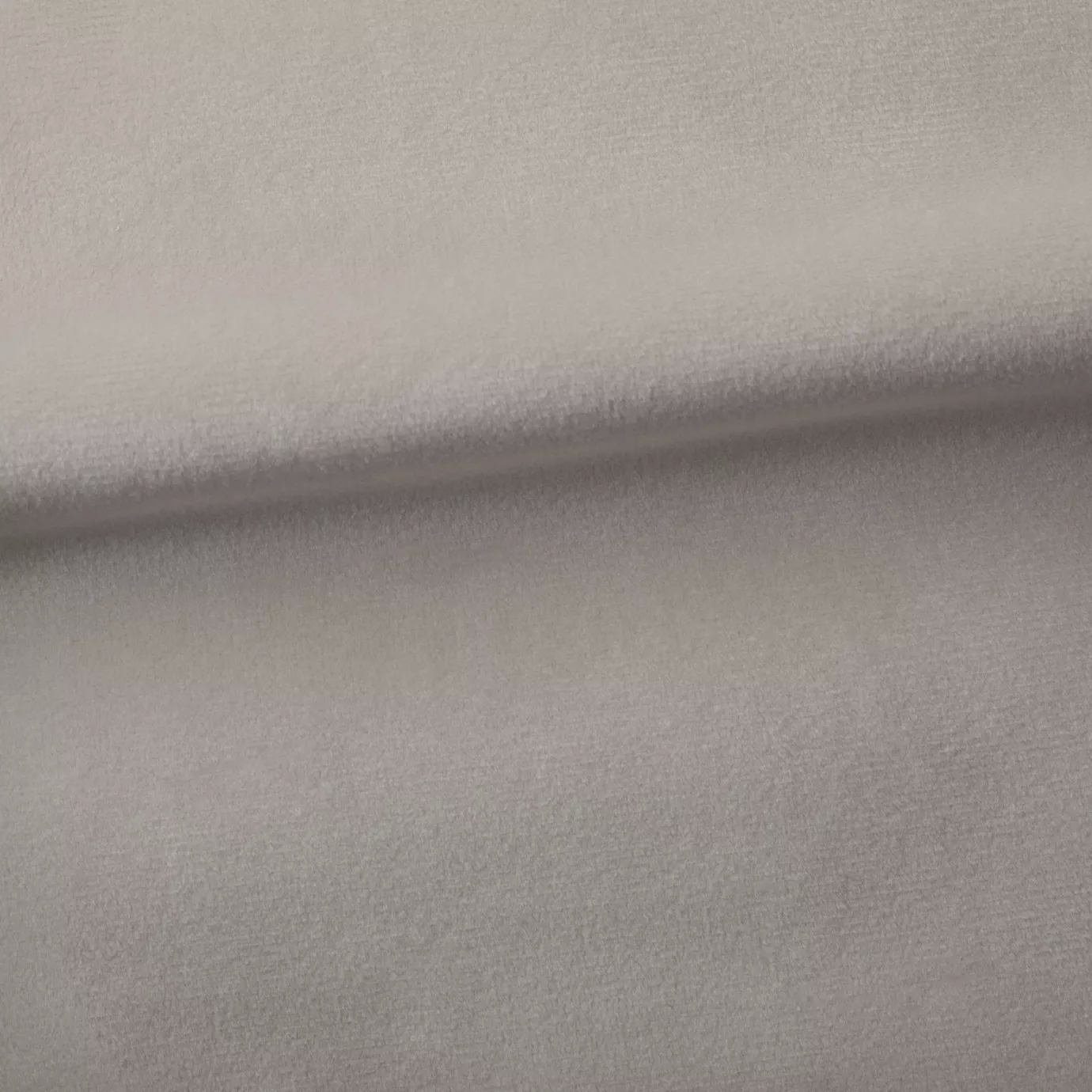 Soft and elegant close-up of a Venice Velvet 02 fabric swatch in a soft and serene rosy beige tone, showcasing its velvety texture and a delicate sheen that gives it a feeling of comfort and understated elegance.
