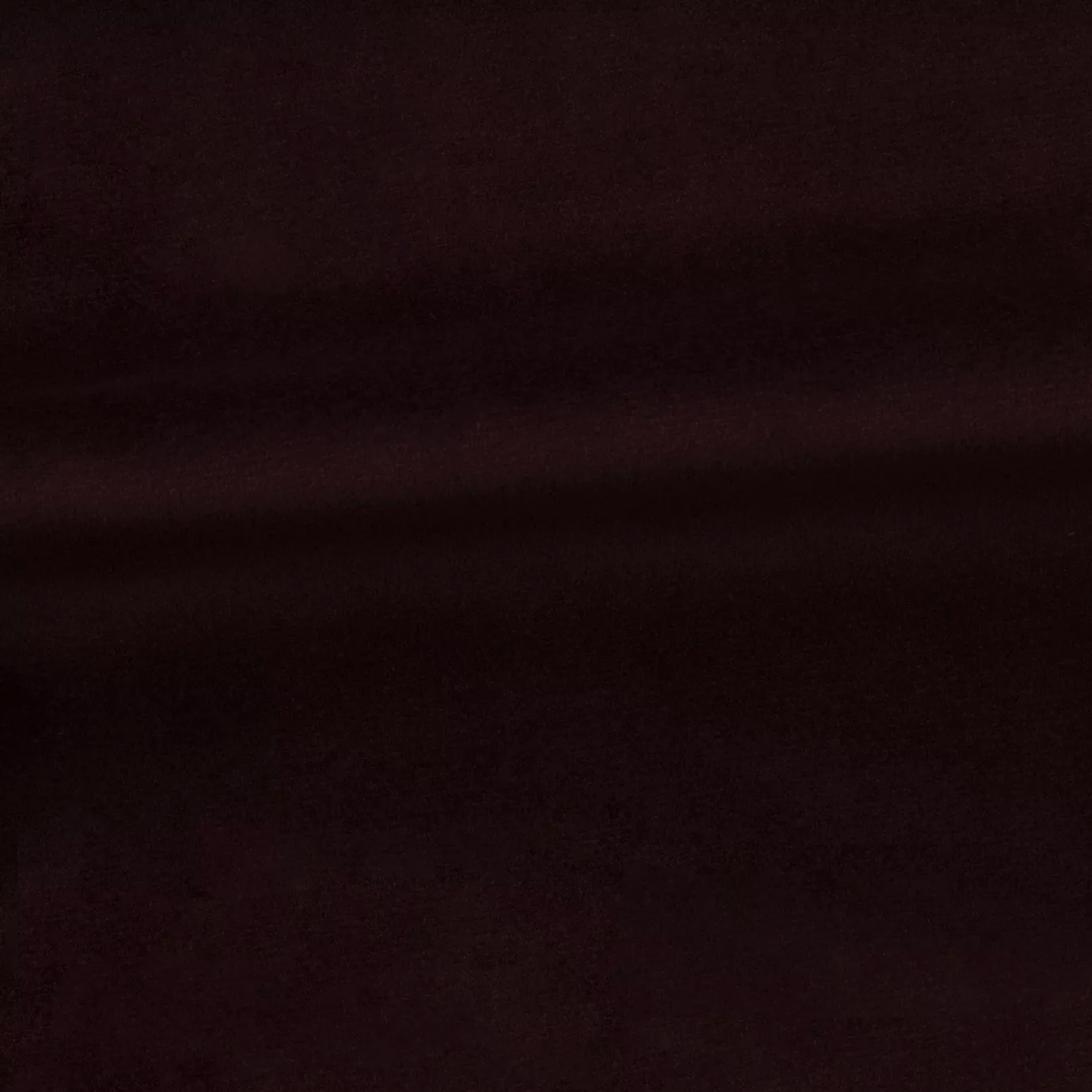 Soft and elegant close-up of a Venice Velvet 11 fabric swatch in a deep and sophisticated burgundy red tone, showcasing its velvety texture and a delicate sheen that gives it a feeling of comfort and intense elegance.