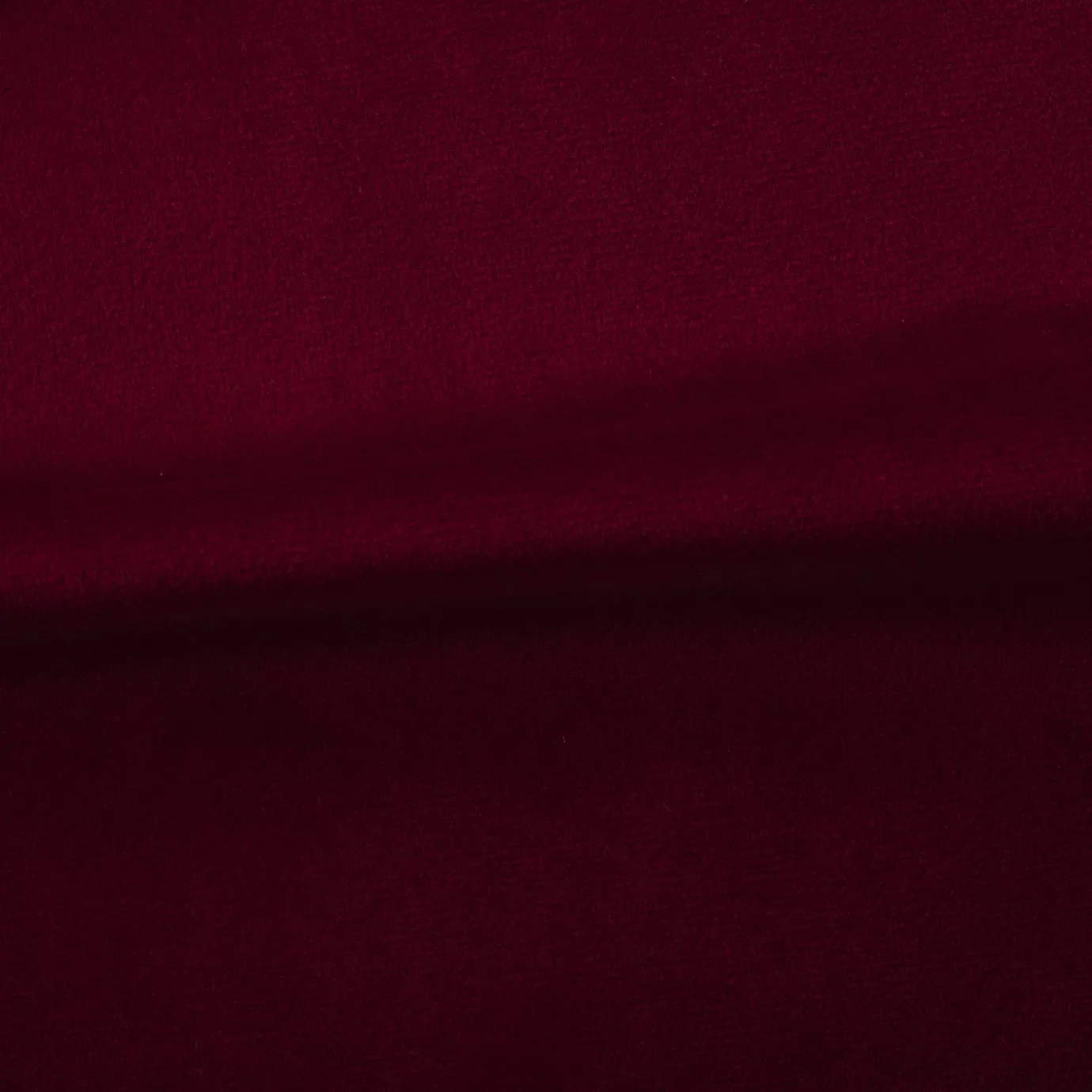 Soft and elegant close-up of a Venice Velvet 12 fabric swatch in a rich and sophisticated red tone, showcasing its velvety texture and a delicate sheen that gives it a feeling of comfort and rich elegance.