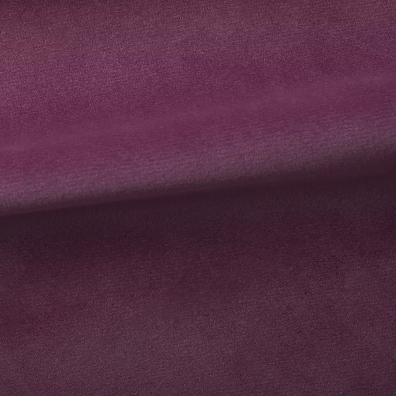 Soft and elegant close-up of a Venice Velvet 16 fabric swatch in a sophisticated and vibrant purplish-pink tone, showcasing its velvety texture and a delicate sheen that gives it a feeling of comfort and intense elegance.