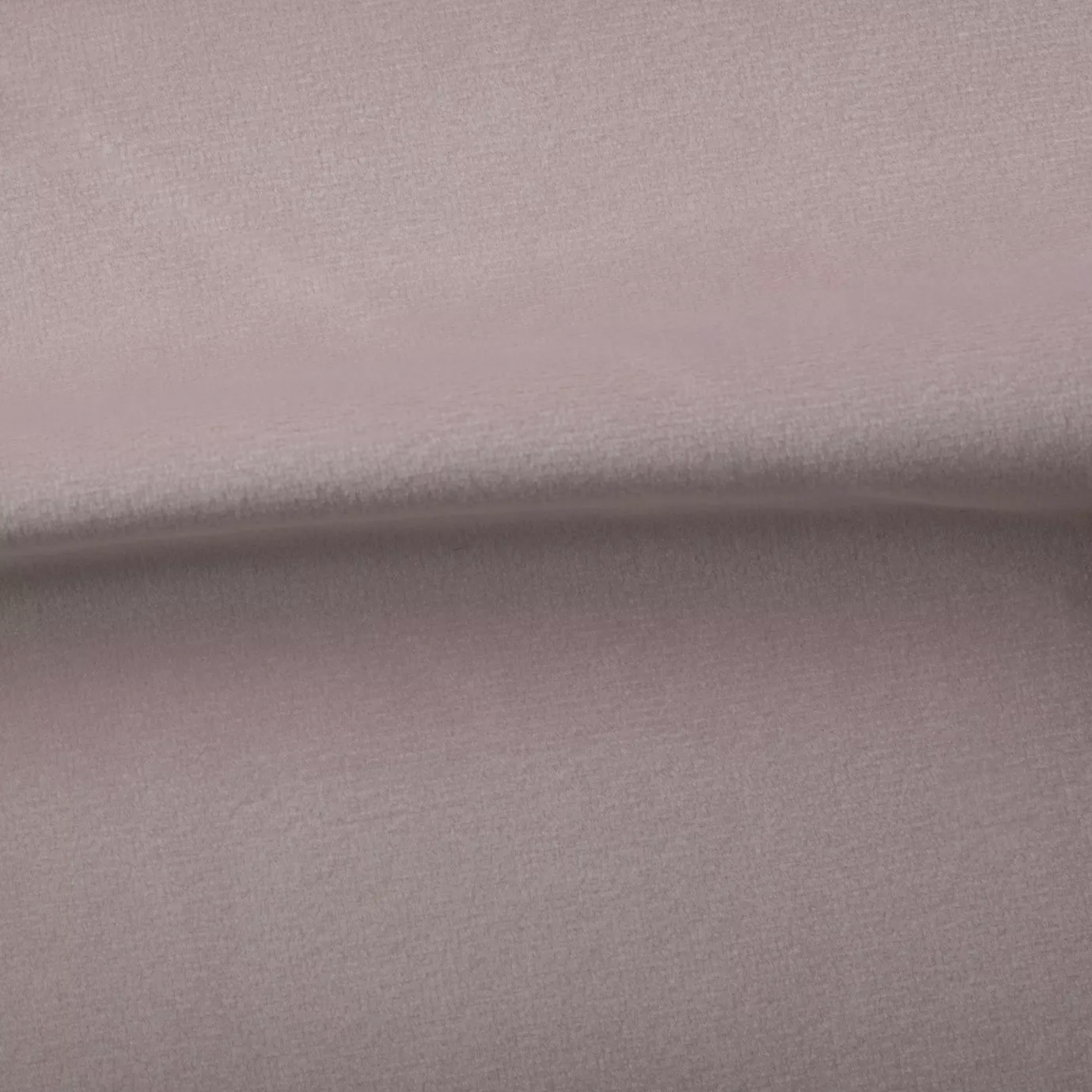 Soft and elegant close-up of a Venice Velvet 17 fabric swatch in a soft and serene pale pink tone, showcasing its velvety texture and a delicate sheen that gives it a feeling of comfort and understated elegance.