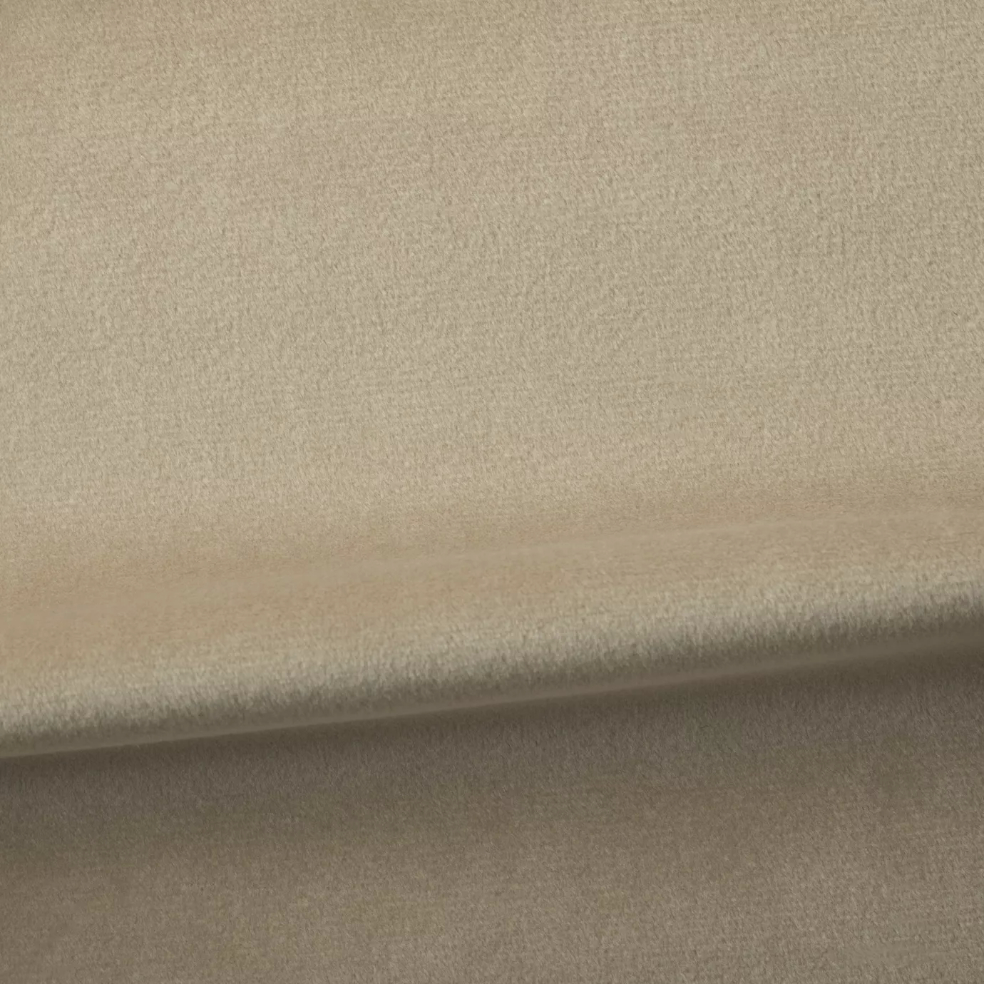 Soft and elegant close-up of a Venice Velvet 32 fabric swatch in a light and natural beige tone, showcasing its velvety texture and a delicate sheen that gives it a feeling of comfort and understated elegance.