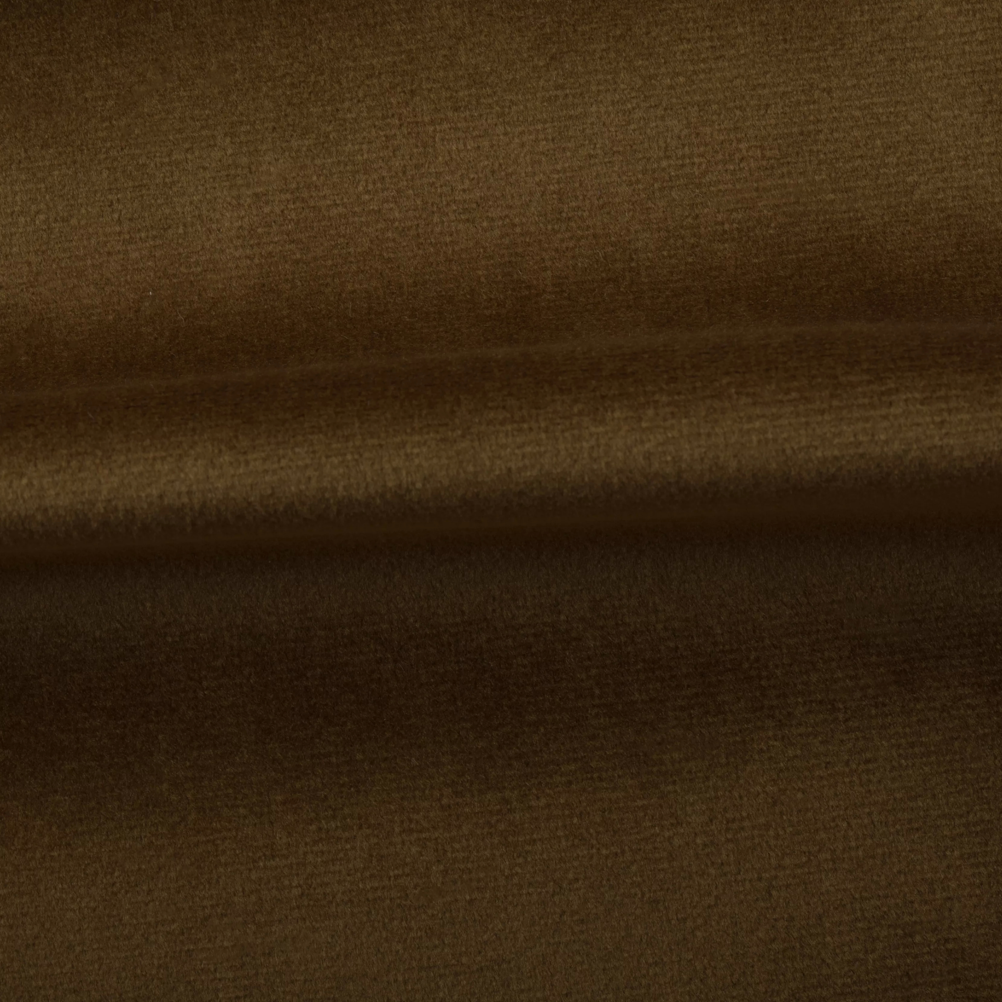 Soft and elegant close-up of a Venice Velvet 34 fabric swatch in a sophisticated and warm golden brown tone, showcasing its velvety texture and a delicate sheen that gives it a feeling of comfort and natural elegance.