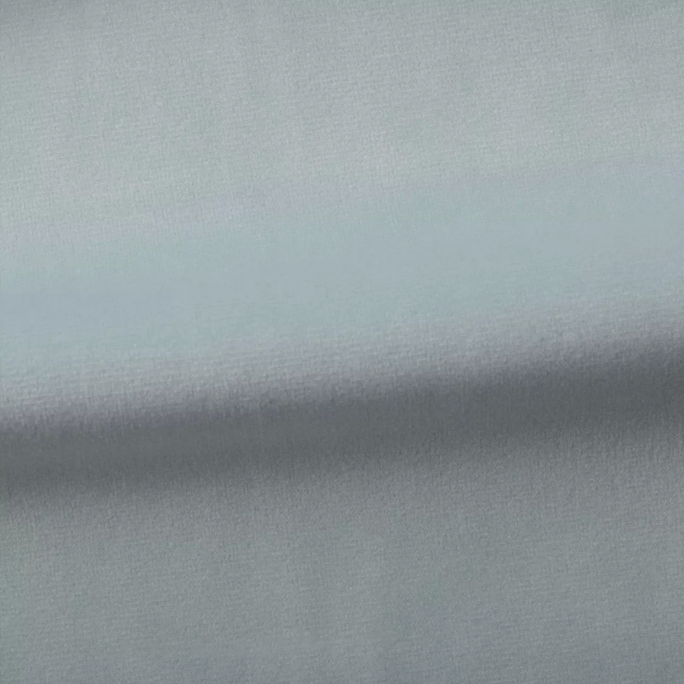 Soft and elegant close-up of a Venice Velvet 59 fabric swatch in a light and serene blue tone, showcasing its velvety texture and a delicate sheen that gives it a feeling of comfort and gentle elegance.