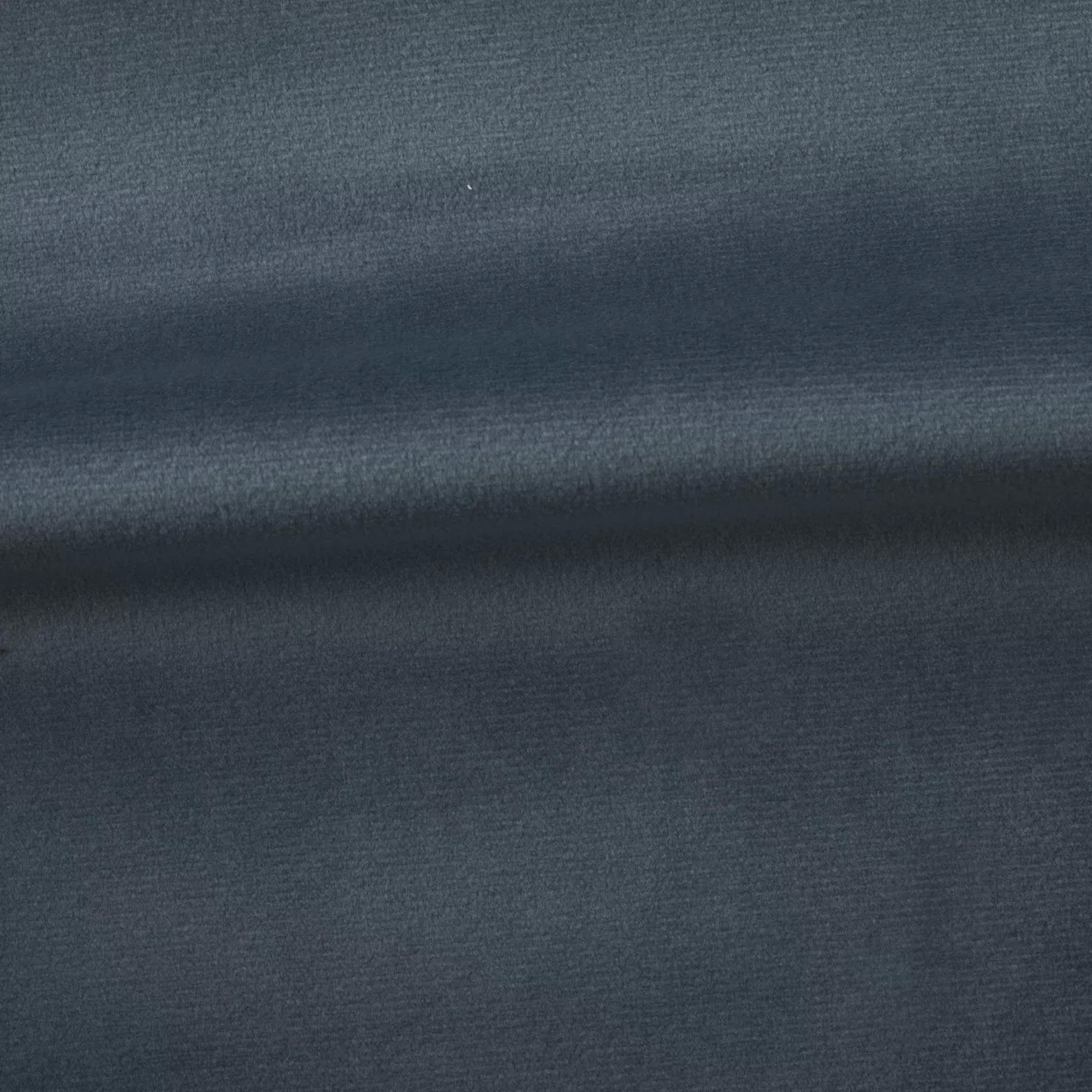 Soft and elegant close-up of a Venice Velvet 60 fabric swatch in a sophisticated and serene gray-blue tone, showcasing its velvety texture and a delicate sheen that gives it a feeling of comfort and understated elegance.