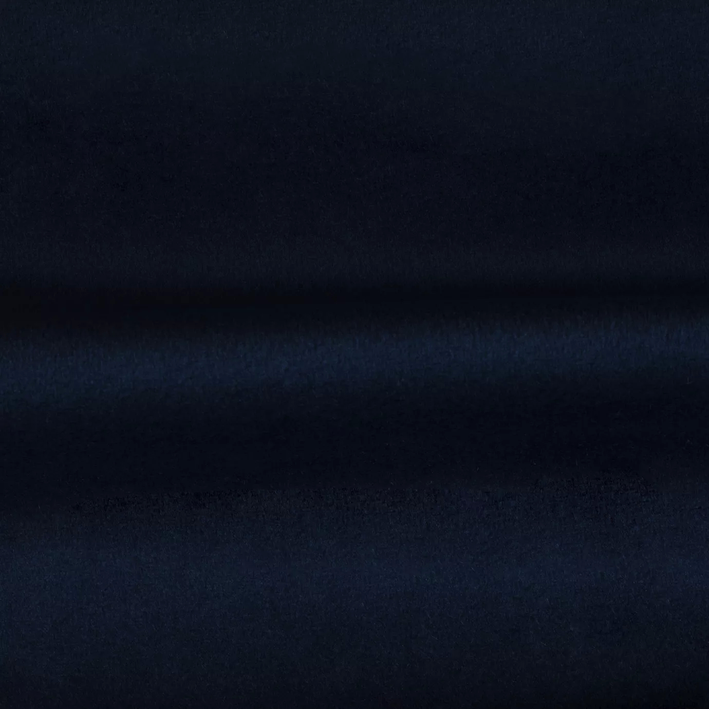 Soft and elegant close-up of a Venice Velvet 67 fabric swatch in a deep and sophisticated navy blue tone, showcasing its velvety texture and a delicate sheen that gives it a feeling of comfort and timeless elegance.