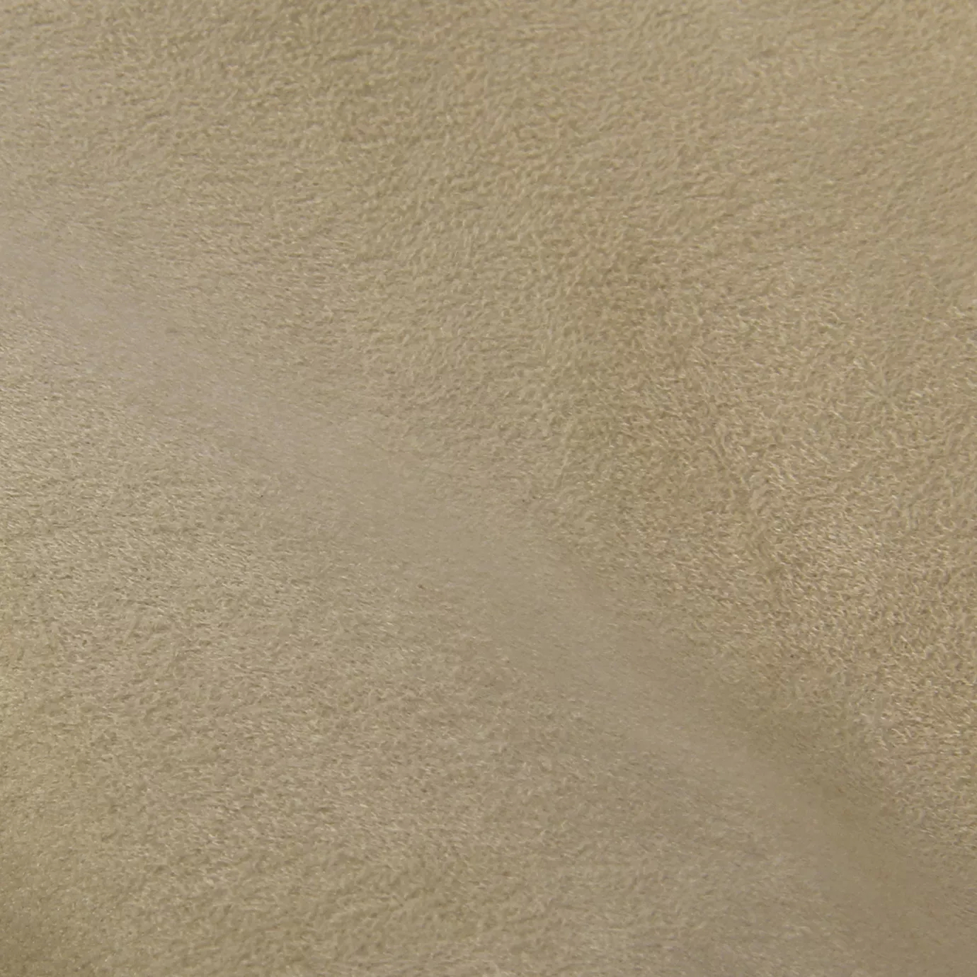 Soft close-up of an Ultra Suede Almondine fabric swatch in a soft and natural almond beige tone, showcasing its delicate texture and a gentle touch that gives it a feeling of comfort and understated elegance.
