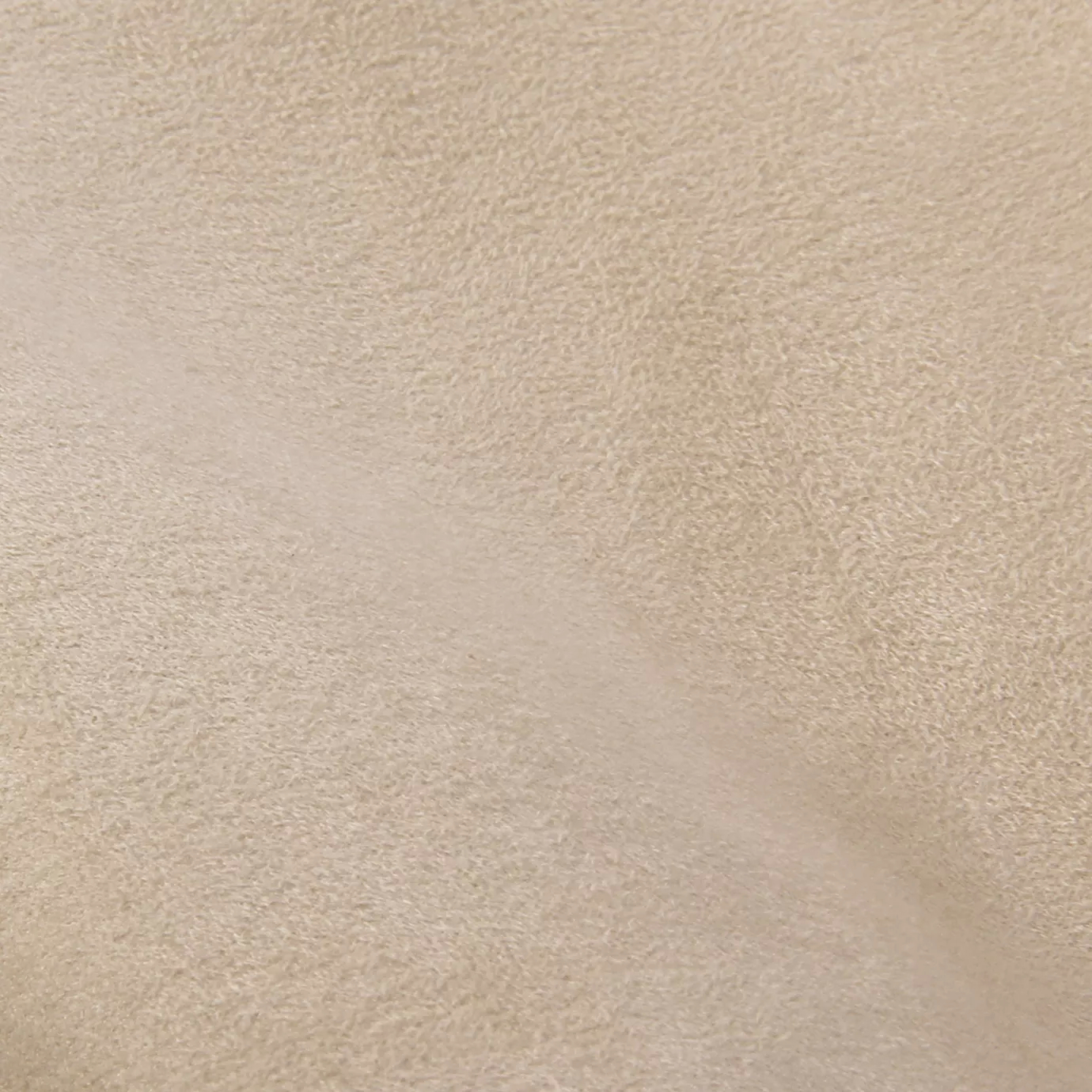 Soft close-up of an Ultra Suede Vanilla fabric swatch in a light and warm beige tone, showcasing its delicate texture and a gentle touch that gives it a feeling of comfort and natural elegance.