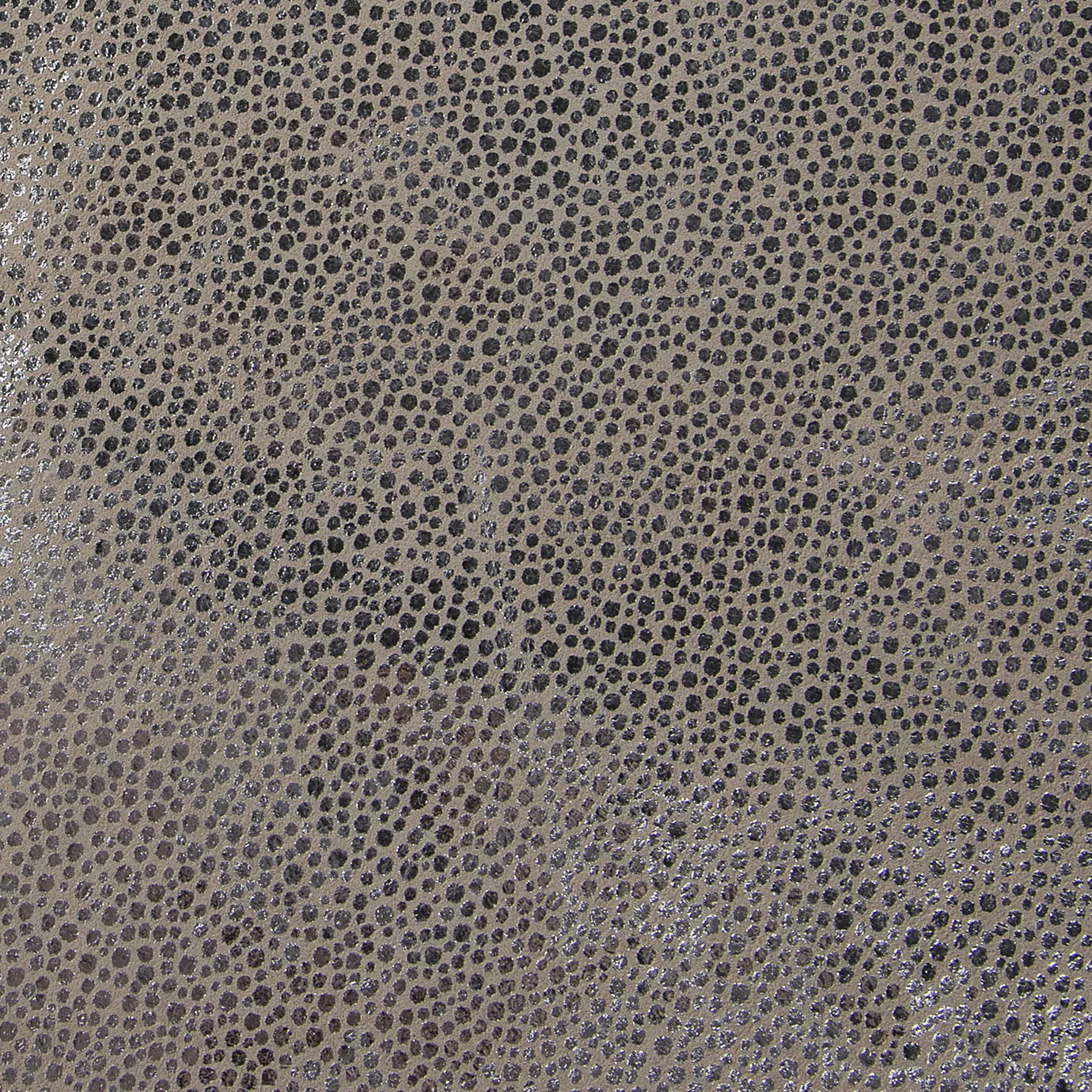 Elegant close-up of a Crico Silver leather swatch with a textured pattern of small dots in beige and metallic silver tones, featuring a smooth surface with a modern and cool shimmer, evoking a feeling of textured sophistication and a touch of contemporary luminosity.