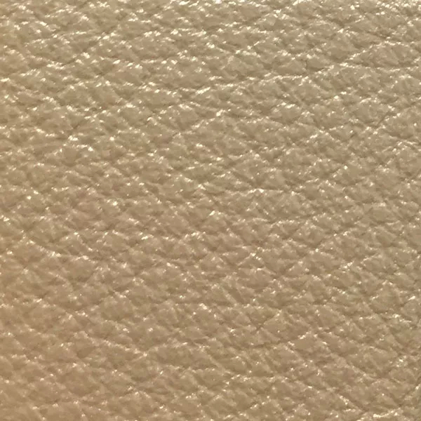 Close-up of a Harbor Silver fabric swatch in a light silver tone with texture, showcasing its raised areas and grooves that give it a modern and elegant feel. The soft sheen highlights the depth of its texture.