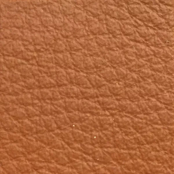 Close-up of a Harbor Caramel fabric swatch in a warm caramel tone with texture, showcasing its raised areas and grooves that give it a natural and elegant feel. The soft sheen highlights the depth of its texture.