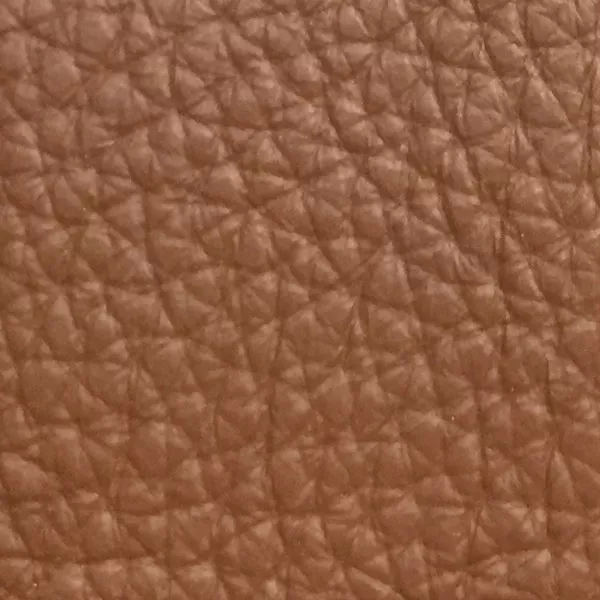 Close-up of a Harbor Coconut Shell fabric swatch in a soft coconut brown tone with texture, showcasing its raised areas and grooves that give it a natural and elegant feel. The soft sheen highlights the depth of its texture.