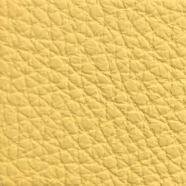 Close-up of a Harbor Corn Silk fabric swatch in a soft straw yellow tone with texture, showcasing its raised areas and grooves that give it a natural and elegant feel. The soft sheen highlights the depth of its texture.