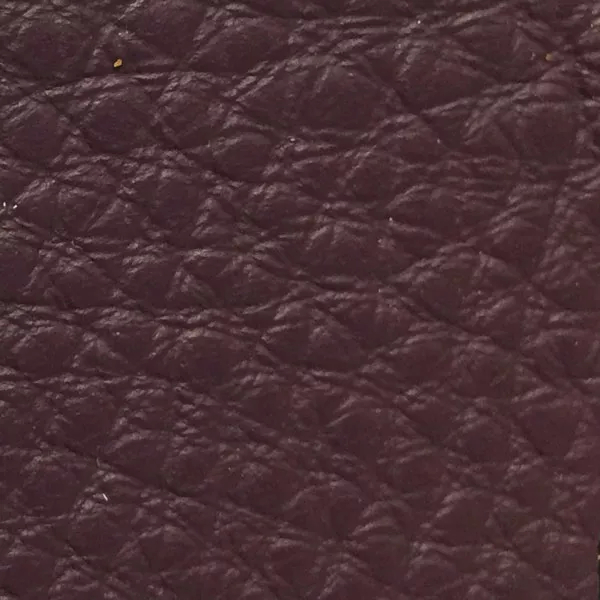 Close-up of a Harbor Deep Purple fabric swatch in a deep purple tone with texture, showcasing its raised areas and grooves that give it a natural and elegant feel. The soft sheen highlights the depth of its texture.