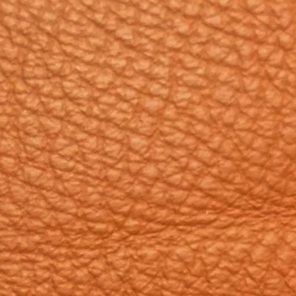 Close-up of a Harbor Ginger Bread fabric swatch in a warm ginger brown tone with texture, showcasing its raised areas and grooves that give it a natural and elegant feel. The soft sheen highlights the depth of its texture.