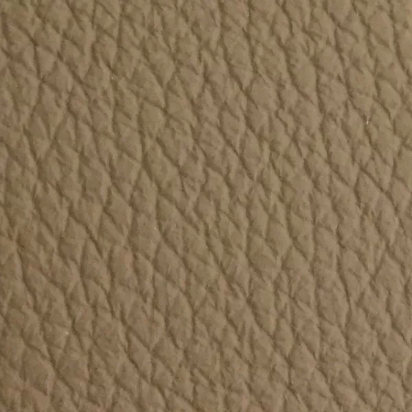 Close-up of a Harbor Ginger Snap fabric swatch in a light grayish-beige tone with texture, showcasing its raised areas and grooves that give it a natural and elegant feel. The soft sheen highlights the depth of its texture.