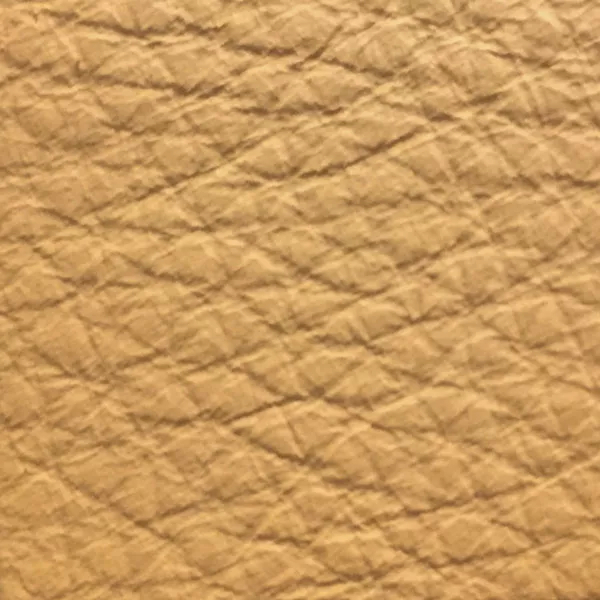 Close-up of a Harbor Honey Yellow fabric swatch in a soft honey yellow tone with texture, showcasing its raised areas and grooves that give it a natural and elegant feel. The soft sheen highlights the depth of its texture.