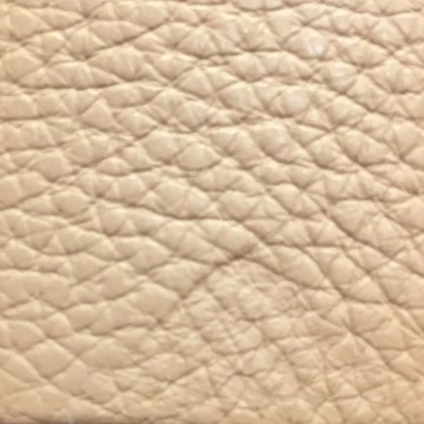 Close-up of a Harbor Latte fabric swatch in a light beige tone with texture, showcasing its raised areas and grooves that give it a natural and elegant feel. The soft sheen highlights the depth of its texture.