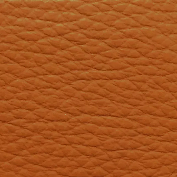 Close-up of a Harbor Orange Ochre fabric swatch in a warm orange ochre tone with texture, showcasing its raised areas and grooves that give it a natural and elegant feel. The soft sheen highlights the depth of its texture.