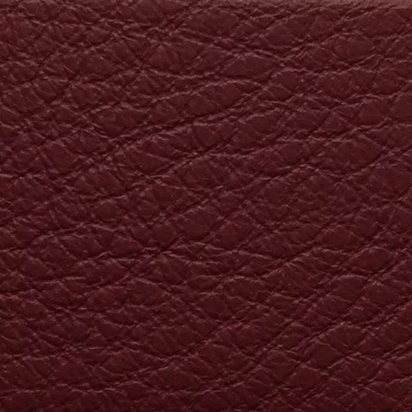 Close-up of a Harbor Oxblood Red fabric swatch in a rich oxblood red tone with texture, showcasing its raised areas and grooves that give it a natural and elegant feel. The soft sheen highlights the depth of its texture.