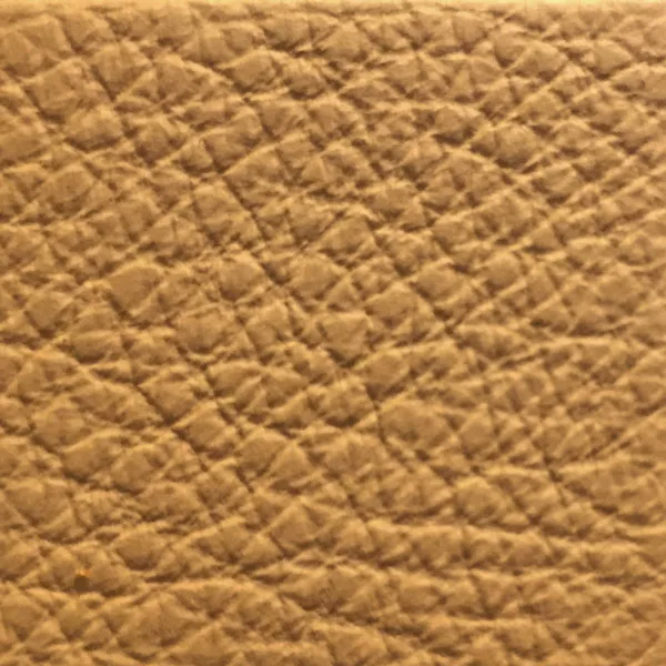Close-up of a Harbor Spruce Yellow fabric swatch in a soft greenish-yellow tone with texture, showcasing its raised areas and grooves that give it a natural and elegant feel. The soft sheen highlights the depth of its texture.