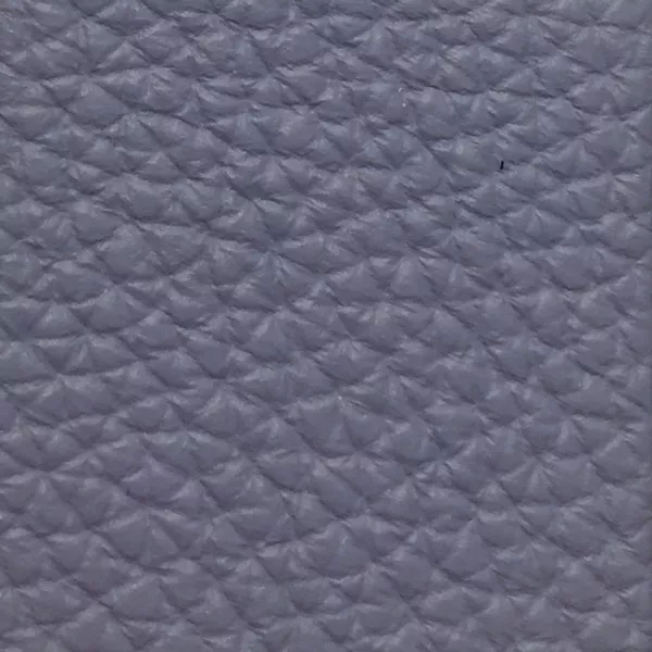 Close-up of a Harbor Stone Wash fabric swatch in a soft grayish-blue tone with texture, showcasing its raised areas and grooves that give it a natural and elegant feel. The soft sheen highlights the depth of its texture.