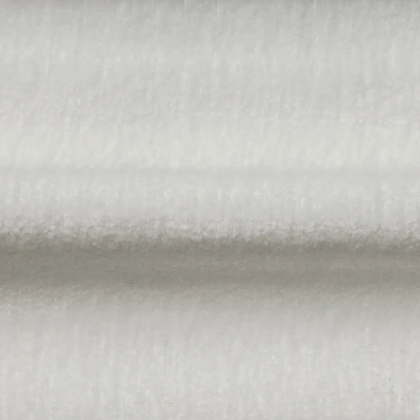 A close-up of the plush, bright white Belle Velvet Fabric, showing its delicate texture and subtle sheen.