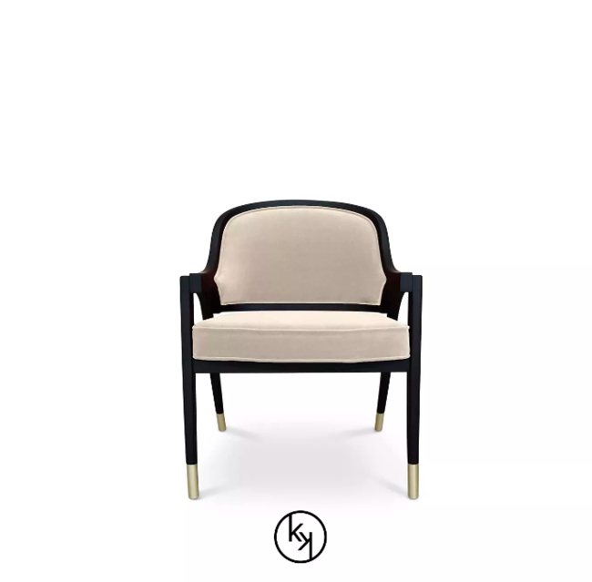 With a cream upholstery and a black structure, the elegant Arendal Chair has golden details on the bottom of its legs.