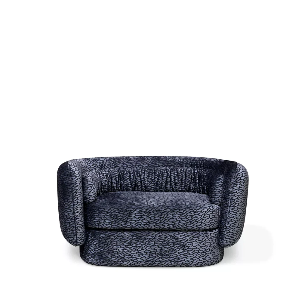 Deb Loveseat has a curvy design and features a dark blue upholstery, with a pattern fabric.