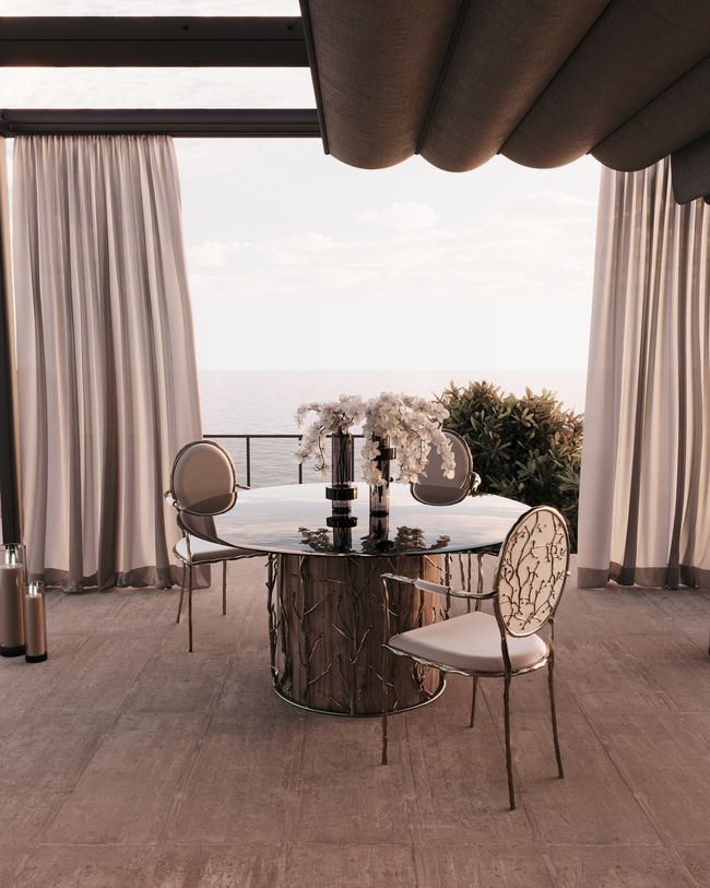 Outdoors Dining Al Fresco space, with teo elegant chairs in cream tones and a glass table.