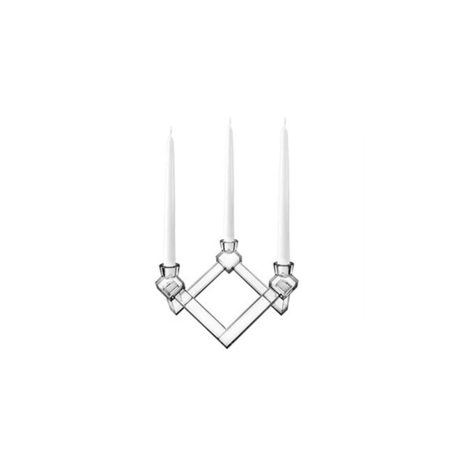 An elegant clear candlestick holding three white candles.