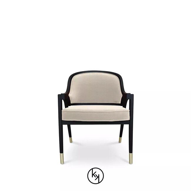Arendal Chair has a creamy upholstery and a black frame with golden tipped feet, resulting in a simple yet stilish design.