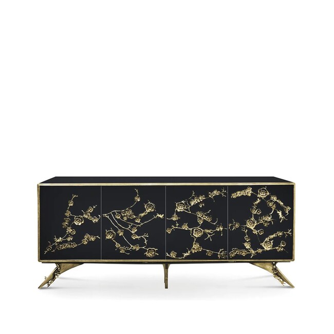 The Spellbound Lacquer Cabinet features a black structure adorned with a golden frame and elegant golden flower-shaped details along its four front doors.