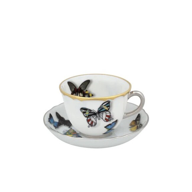 A set of a coffee cup and saucer with colorful butterfly representations.