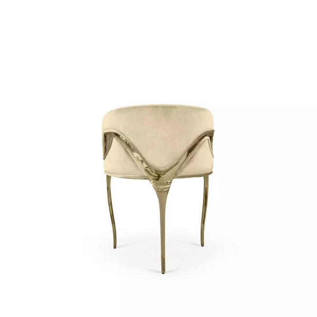 Display of Chandra Dining Chair, demonstrating its distinctive feature of only having 3 legs, its frame contrasting with the elegant creamupholstery.