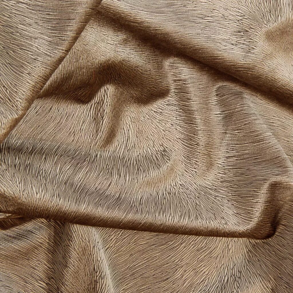 A luxurious selection of textiles and fabrics from KOKET, featuring a variety of rich textures, vibrant colors, and intricate patterns designed to enhance the elegance and style of any furniture piece.