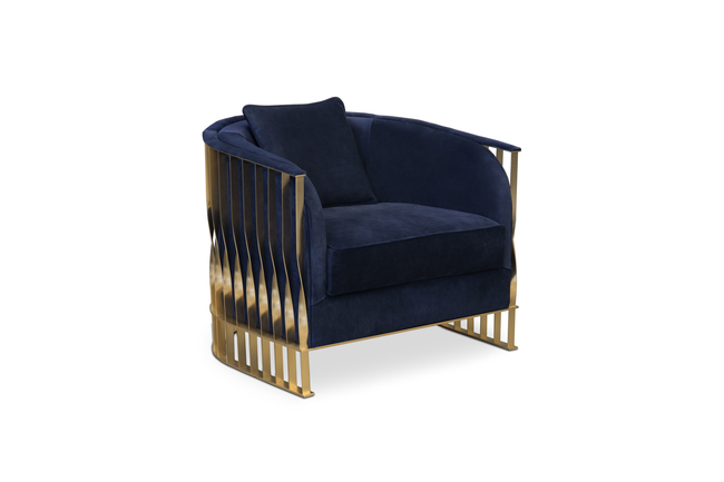 With a dark-blue velvety upholstery, the Mandy Armchair has the distinctive feature of having a twisted high-gloss metal structure in golden hues.