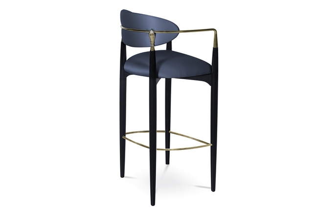 Side view of the Nahéma Bar Stool, showcasing the black structure, dark blue upholstery and the luxurious golden hand-shaped detail on the backrest.
