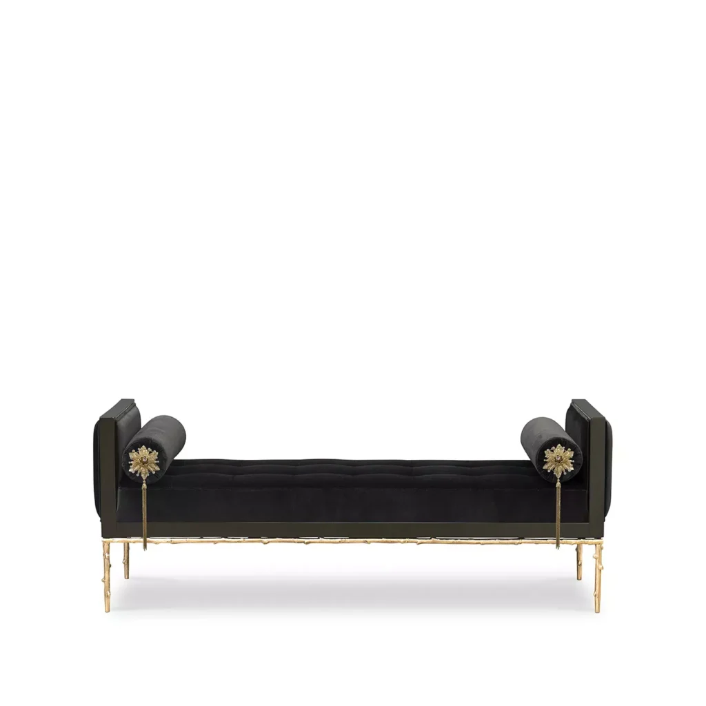 A black upholestry daybed with golden structure and floral-themed details.