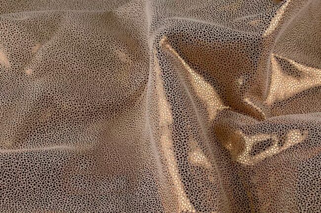 Texturized fabric with golden reflexions.
